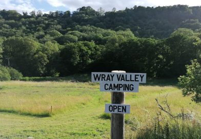 Wray Valley Campsite sign - open for business, view of camping field