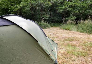 Tent in nearly wild camping area surrounded by trees. Biodiversity corridor