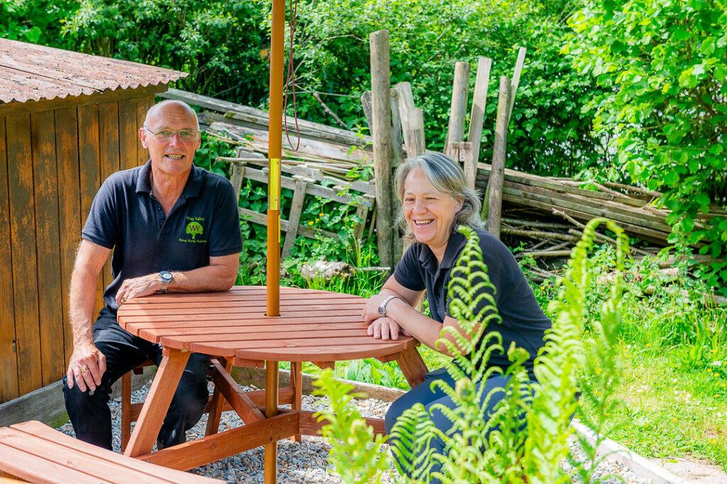 Michelle and Kevin sitting at a picnic table. 