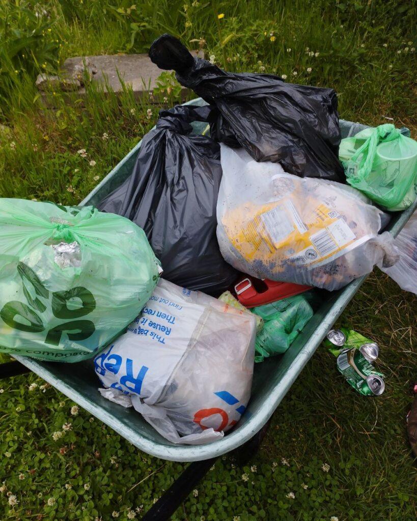 Wheelbarrow full of rubbish waitng to be sorted. 