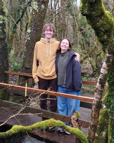 Prize draw winners - enjoying their weekend at Wray Valley standing on the woodland footbridge over the river