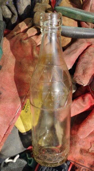 Vintage 1926 glass Tizer bottle discovered in the woodland soil during volunteer nature conservation at Wray Valley.