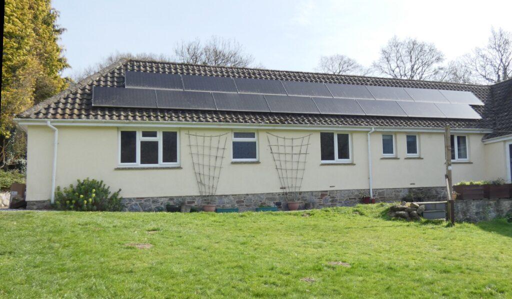 Array of solar panels above guest bedrooms on bungalow