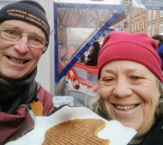 Wray Valley owners Michelle and Kevin enjoying stroopwafels on a street in Amsterdam during their sustainable January trip via Eurostar.